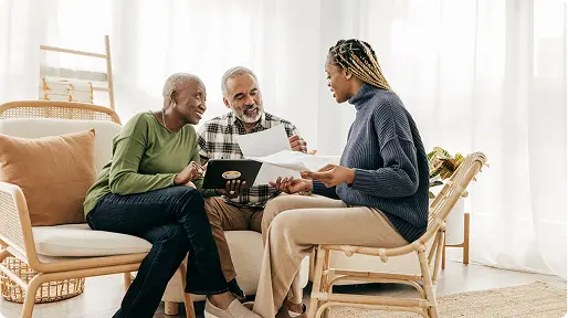 Family discussing documents on couch